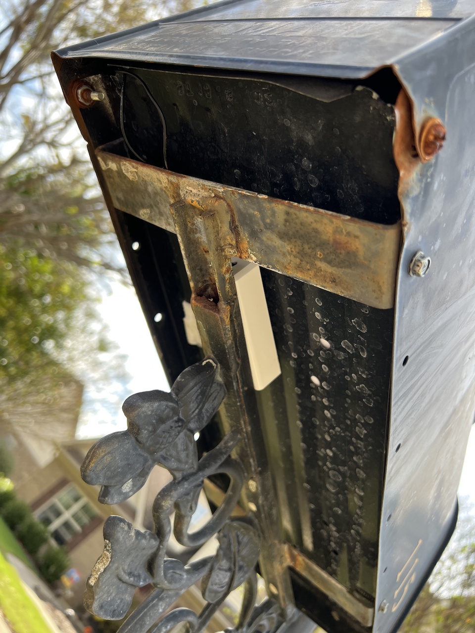 Underneath, showing the sensor enclosure nestled up under the mailbox.